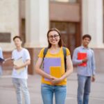 student-girl-standing-near-university-building-out-2021-08-29-02-26-16-utc-min-1024×641